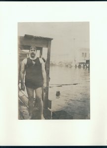 Wet Man in a Swimsuit on a Dock Beside a Lake